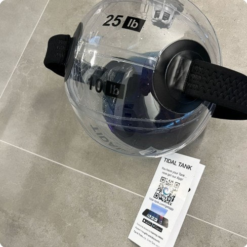 A sphere on concrete with its 25 lb load marking readable.