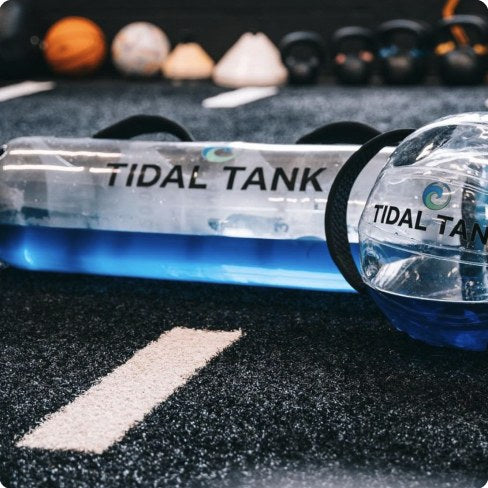 Two water-filled tubes laid out on turf.