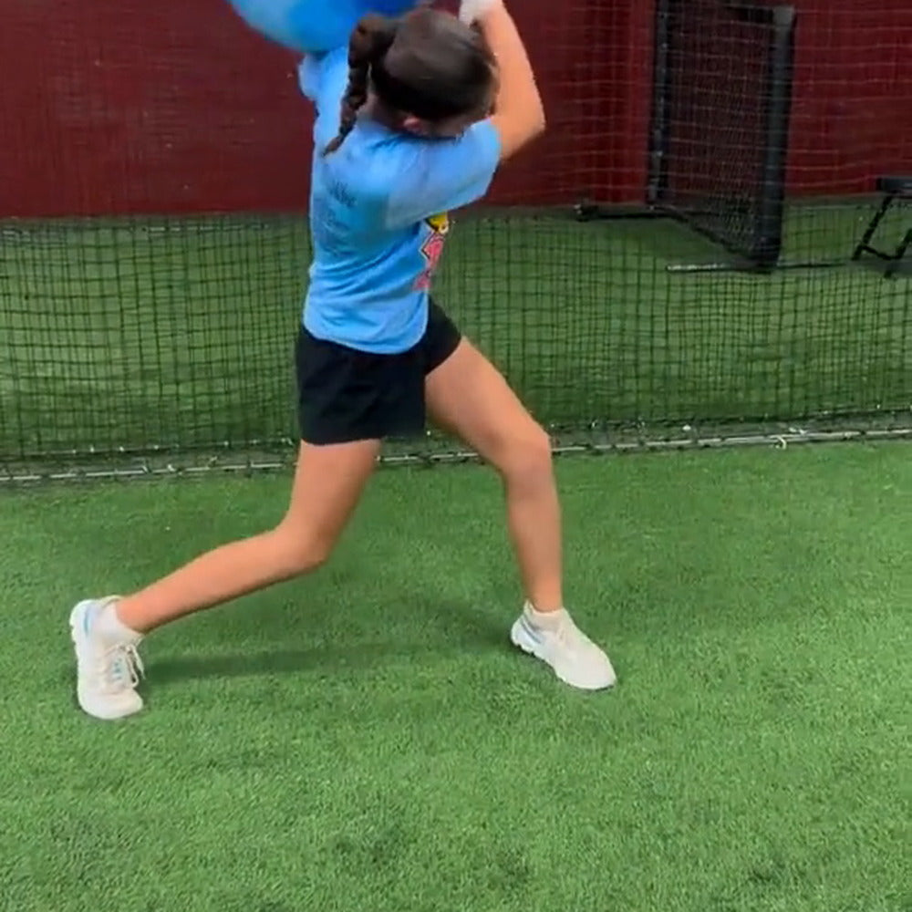 A hitter swinging off a tee after water-weight rotational work