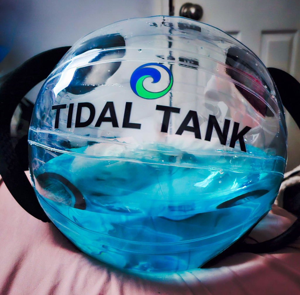 Close-up of a sphere filled halfway, the water sitting level inside it.