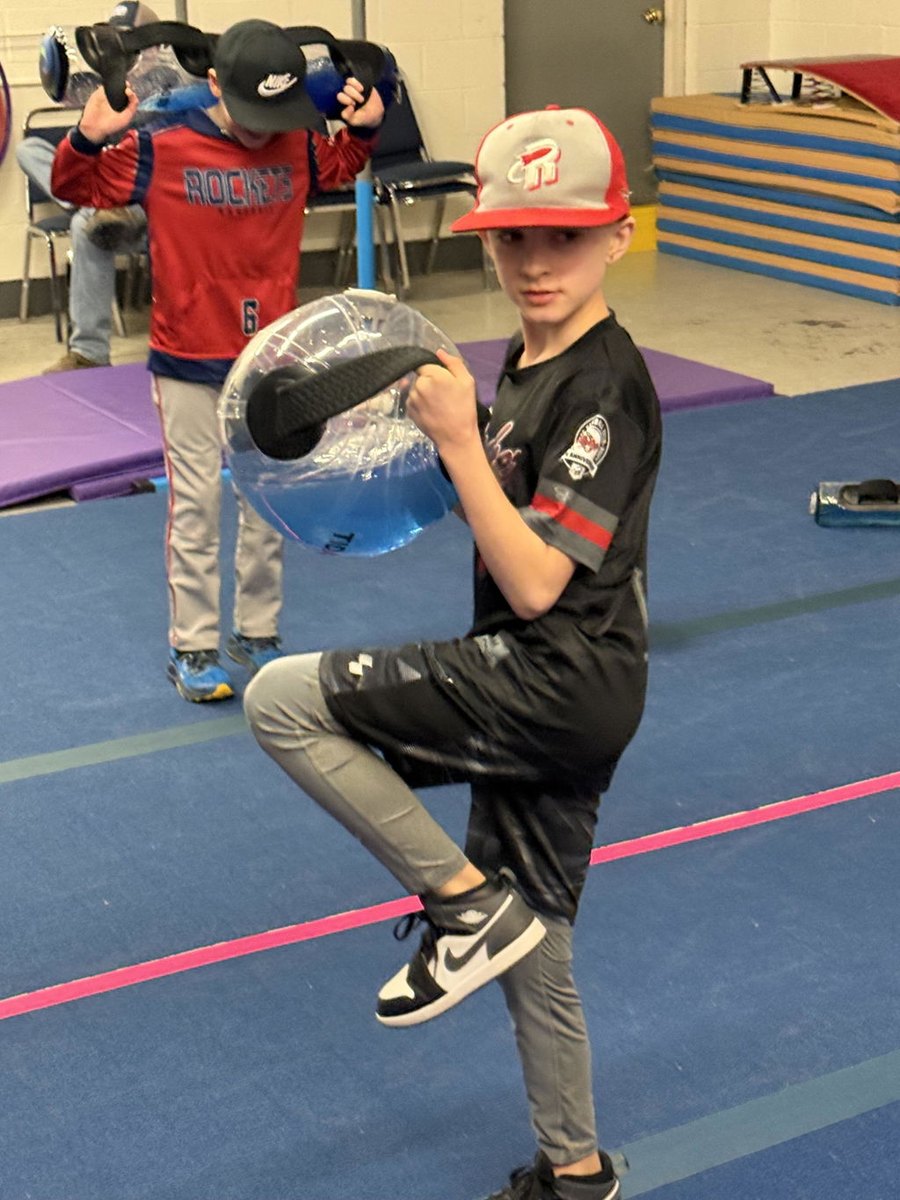 A youth class training with water-filled spheres.